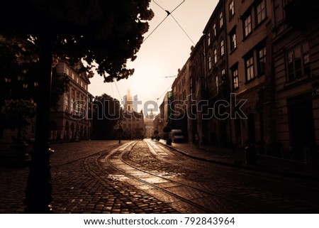 old street with a pavement and sunrise over a beautiful city Lviv, Ukraine