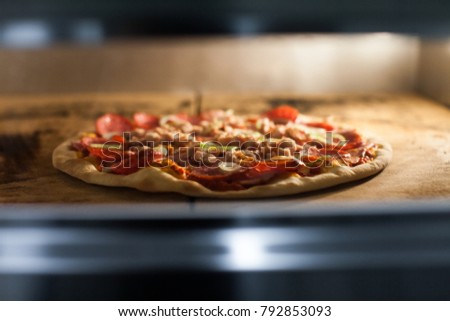 Pizza is cooked in the oven. Pizza is cooked in the Combi oven . Italian pizza. The process of cooking.
 Royalty-Free Stock Photo #792853093