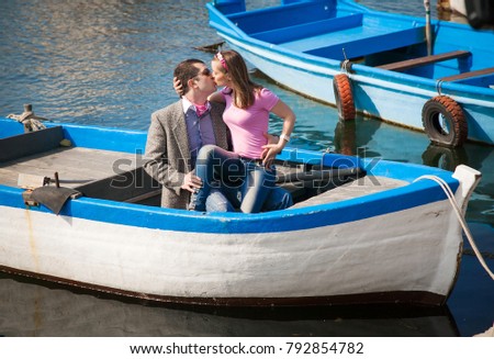 two young people kissing in a boat, ocean background, background for lovers' day
