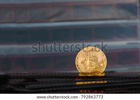  Bitcoin cryptocurrency over Exposed and Developed old film negative strips background.