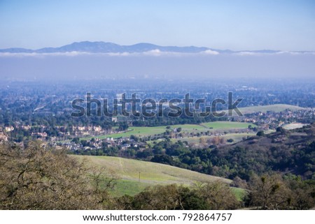 Aerial view of Cupertino and San Jose, Silicon valley; south San Francisco bay area; Mount Hamilton summit (and the observatories) in Diablo mountain range in the background; California