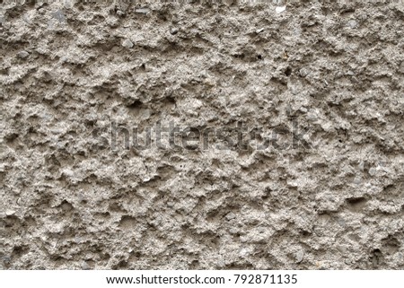 Facade plaster texture in slovak called Brizolit. Single layer sprayed cement plaster wallpaper. Single-ply monolithic plaster decorative background. Exterior building facade structure backdrop.