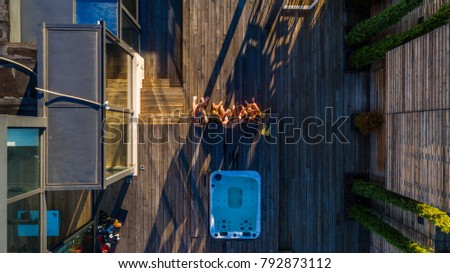 Group of friends having fun on a penthouse terrace, view from above