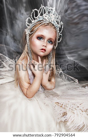 close up portrait of beautiful girl with crown. professional winter makeup