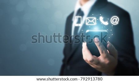 Businessman hand holding smart phone with icon mobile phone, mail, telephone and address. Customer service call center contact us concept Royalty-Free Stock Photo #792913780