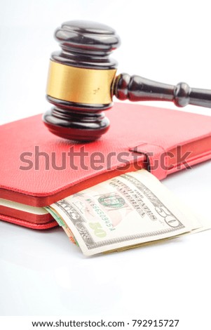Wood gavel hammer and usd banknote with corruption concept.