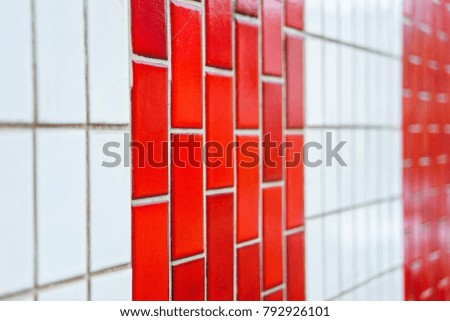 Red Vertical tiles on the facade. Glossy tiles. The decoration of the facades of buildings. Texture and texture