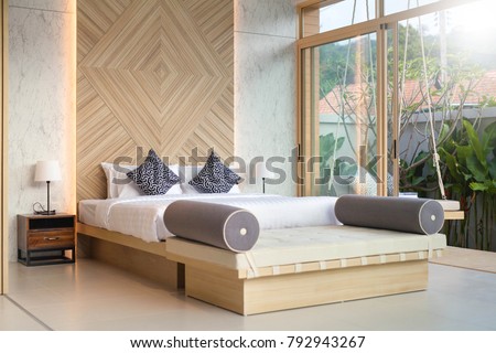 real Luxury Interior design in bedroom of pool villa with cozy king bed with high raised ceiling  Royalty-Free Stock Photo #792943267