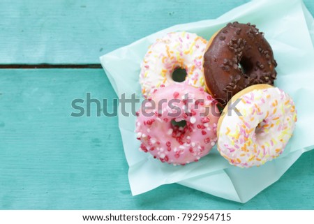 sweet donuts with sugar and chocolate colored glaze