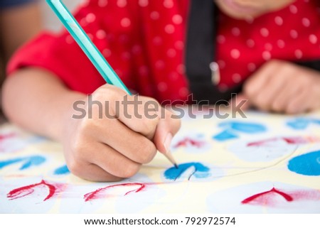 
  Little girl painting at table