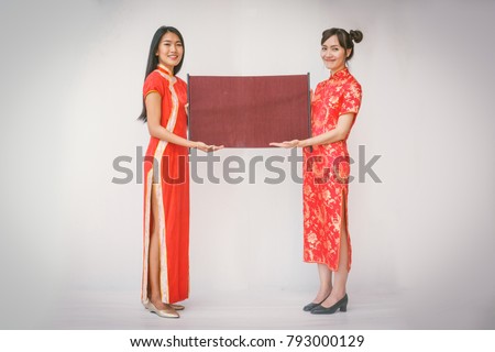 Two women couple holding banner with Chinese new year.