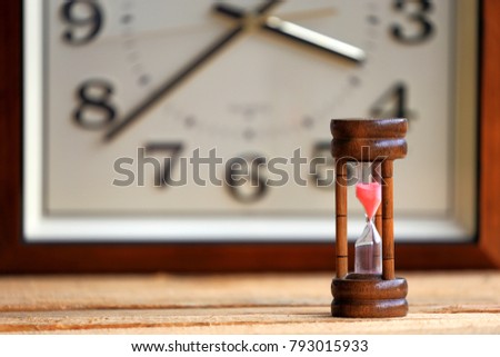 Hourglass on wooden floor selective focus and shallow depth of field
