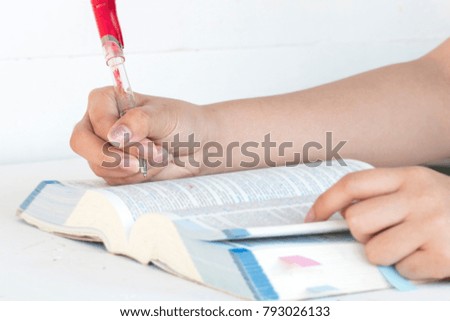 hand of woman reading and note dictionary english for study