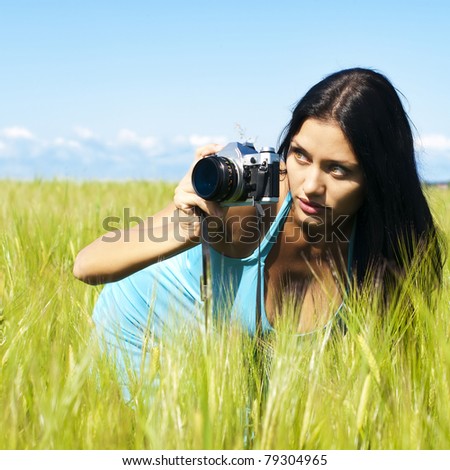 Portrait of the beautiful woman with a camera