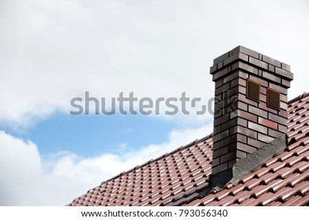 Roof made of ceramic tiles and a brick chimney. Royalty-Free Stock Photo #793056340