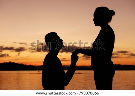 Young man ask  his girlfriend for wedding on Valentine's day .silhouette concept.