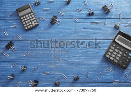 Office supplies and copy text space on wooden background, top view