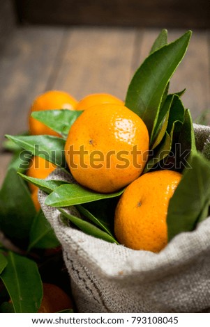 Fresh ripe mandarines on the rustic wooden background. Selective focus. Shallow depth of field.
