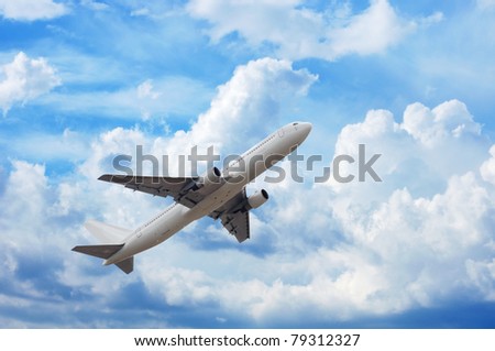 airplane in the sky full of fluffy clouds