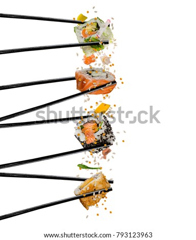 Pieces of sushi with wooden chopsticks, separated on white background. Flying food and motion concept. Very high resolution image