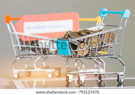 Many coins and tag Travel insurance in small shopping cart on tablet. Concepts online shopping consumers can buy insurance directly from anywhere, home or office. Taking few clicks via Internet web.