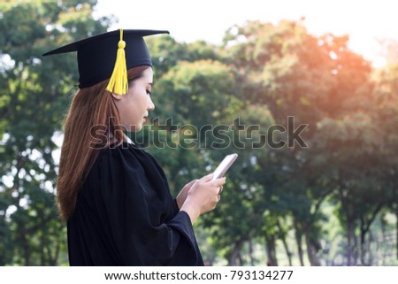 Asian female student graduate holding smart phone with check job
