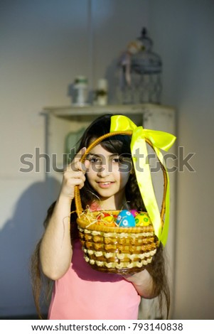 Beautiful little girl with bright Christian Easter painted eggs.