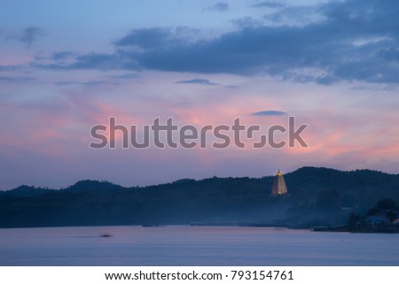 twilight time Golden Puttakaya chedi (pagoda) landscape scene at Sangkhlaburi district, Kanchanaburi, Thailand.