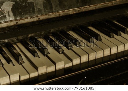 Part of old musical piano keyboard background. Close-up of an old harvest of piano-tree. Broken old broken piano. Musical keys close-up of old musical instrument. Vintage background with music theme
