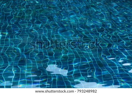 Blinding water in pool laid out with blue tiles