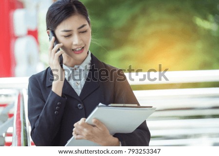 Asian business woman use mobile phone technology talk about working
