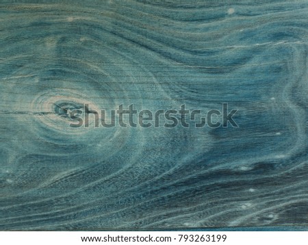 Aged wooden planks  with gentle texture  of annual rings. Wooden surface moored into navy blue color, 