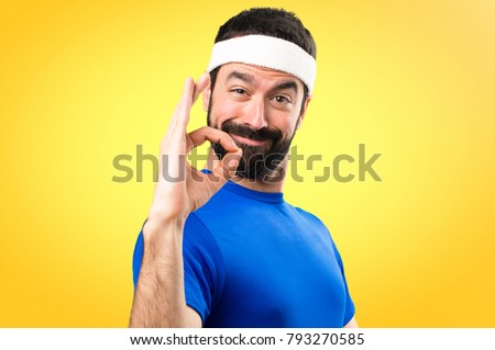 Funny sportsman making OK sign on colorful background