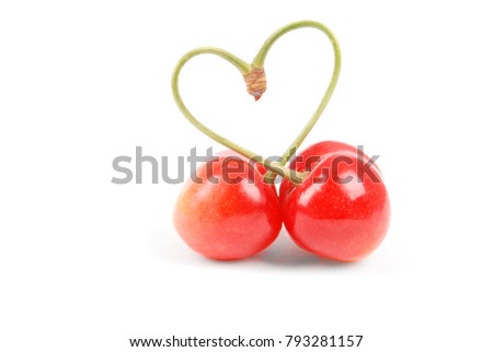 Pair of sweet cherry fruits with heart shaped stem isolated on white background