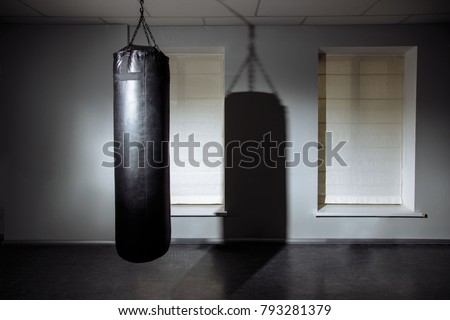 Empty modern fight club with punching bag for practicing martial arts