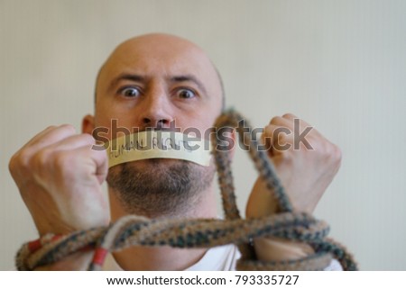 frightened bound man with a sealed mouth