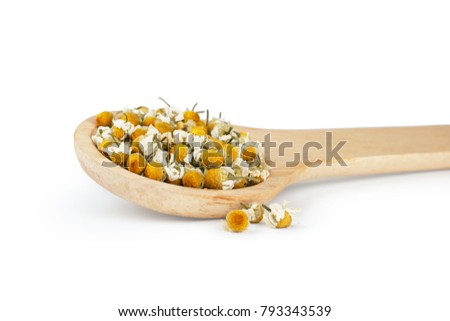 Dried chamomile flowers and wooden spoon isolated on white background