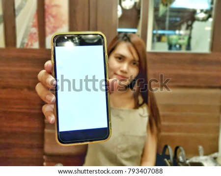 Girl women holding the telefphone for to show the screen 