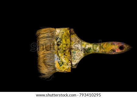 Colored yellow old paint brush of the black background