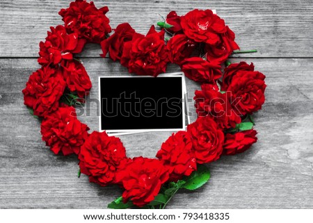 red rose flowers heart shaped with blank photo frame on rustic wooden background. Valentine day concept. top view. mock up