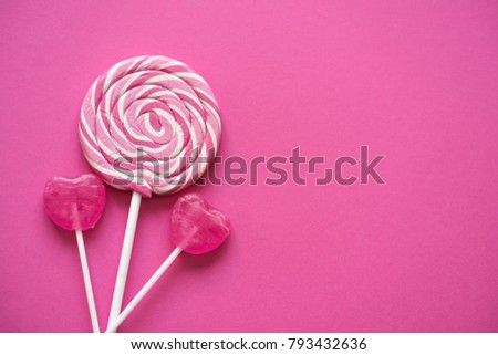 Pink Valentine's day heart shape lollipop candy on empty pink paper background. St. Valentine's Day or Anniversary concept. Royalty-Free Stock Photo #793432636