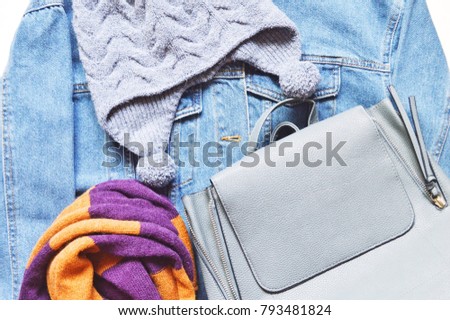 Blue denim jacket, woolen hat, knitted scarf and lady bag. Women's clothes, autumn and winter outfit. Flatlays