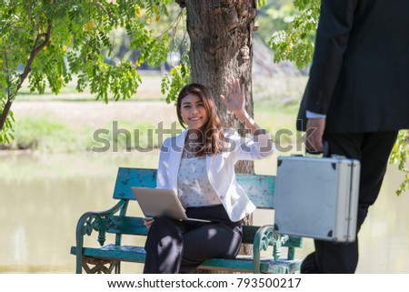 Beautiful woman sitting in folding chair with laptop near the pond in park, Business woman show motion / Business man in black suit carrying a hard suitcase lean against the tree 