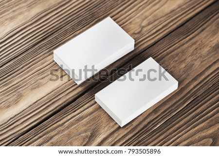 Close Up of two blank horizontal business cards at wooden background