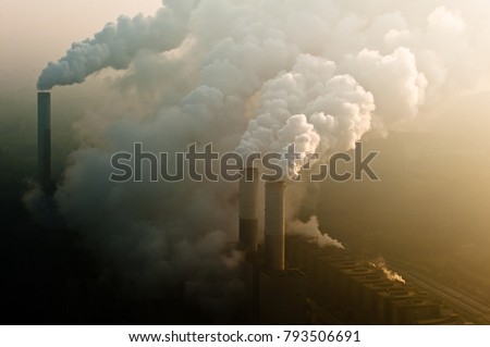 smoking chimney of a coal power plant Royalty-Free Stock Photo #793506691