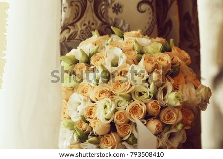 Photo closeup front view ball-shaped elegant wedding bouquet of fresh pastel pink white roses flowers buds with ribbons for bridal ceremony on white lace and curtain background, horizontal picture 