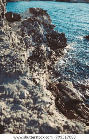 The rocks and stones on the coast of Ionian Sea, island Milos, Greece