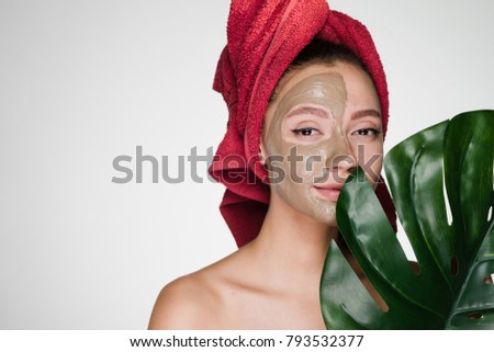 woman with a towel on her head has put a mask on her face