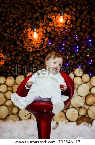 Cute little girl sitting on the chair