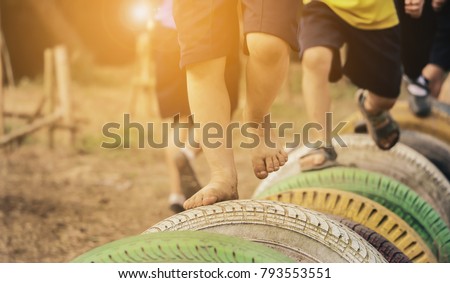 Kids playing in the playground. Running on tires.selective focus Royalty-Free Stock Photo #793553551